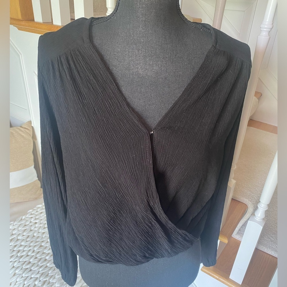 NWOT Free People size XS Black long sleeve faux wrap top. Hook and eye closeure